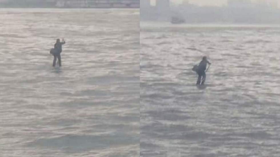 En retard à une réunion, ce monsieur en costume s’est dit qu’il irait plus vite en traversant l’Hudson River en paddle